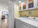 Convenient laundry area with washer, dryer, storage cabinets, and glimpses of the ocean view at 2501 S Ocean Blvd. # 508, North Myrtle Beach, SC 29582