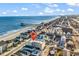 Expansive aerial shot showcasing beachfront condos and nearby beach homes in a vibrant coastal setting at 301 N Waccamaw Dr. # 311, Garden City Beach, SC 29576