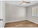 Cozy bedroom featuring wood-look flooring, a ceiling fan, and a sunlit window at 301 N Waccamaw Dr. # 311, Garden City Beach, SC 29576