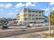Exterior of condo building with multi-level patios and street view at 301 N Waccamaw Dr. # 311, Garden City Beach, SC 29576
