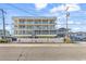 Charming condo complex with multiple balconies, white railings, and inviting curb appeal at 301 N Waccamaw Dr. # 311, Garden City Beach, SC 29576
