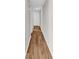 Hallway with laminate flooring, leading to a door, freshly painted at 301 N Waccamaw Dr. # 311, Garden City Beach, SC 29576