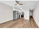 Open concept kitchen with stainless steel appliances, white cabinets, and wood-look flooring at 301 N Waccamaw Dr. # 311, Garden City Beach, SC 29576