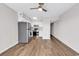 Open concept kitchen with stainless steel appliances, white cabinets, and wood-look flooring at 301 N Waccamaw Dr. # 311, Garden City Beach, SC 29576