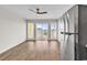 Bright living room featuring wood-look flooring, ceiling fan, and a sliding door to the outside at 301 N Waccamaw Dr. # 311, Garden City Beach, SC 29576