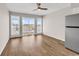 Living room with laminate flooring, view to outdoor balcony, and modern fridge at 301 N Waccamaw Dr. # 311, Garden City Beach, SC 29576