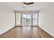 Spacious, airy living room featuring wood-look flooring and a sliding door to the outside at 301 N Waccamaw Dr. # 311, Garden City Beach, SC 29576