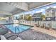 Community pool with lounge chairs and privacy fence at 301 N Waccamaw Dr. # 311, Garden City Beach, SC 29576