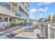 Community pool with tables and lounge chairs located at Garden Sands at 301 N Waccamaw Dr. # 311, Garden City Beach, SC 29576