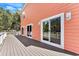 Back deck with salmon colored siding and 3 glass doors providing indoor and outdoor living at 3304 Palm St., North Myrtle Beach, SC 29582