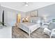 A cozy bedroom with a comfortable queen-size bed and ensuite bath, illuminated by a ceiling fan at 3304 Palm St., North Myrtle Beach, SC 29582