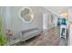 Elegant hallway with grey wood-look flooring, a decorative mirror, and a cozy bench at 3304 Palm St., North Myrtle Beach, SC 29582
