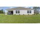 Well-maintained backyard with a covered patio, lush green lawn, and serene outdoor space at 3533 Ashridge Way, Conway, SC 29526