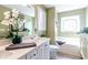 Well-lit bathroom features a tub and vanity with sage green walls, creating a refreshing ambiance at 417 Pennington Loop, Myrtle Beach, SC 29588