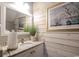 Cozy bathroom featuring rustic wood paneling, granite counters, and decorative mirror and artwork at 417 Pennington Loop, Myrtle Beach, SC 29588