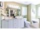 Bright bathroom with dual sinks, framed mirror, and a separate tub, perfect for relaxation at 417 Pennington Loop, Myrtle Beach, SC 29588