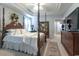 Spacious bedroom featuring a four-poster bed, tray ceiling, and a charming floral arrangement at 417 Pennington Loop, Myrtle Beach, SC 29588