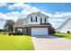 Charming two-story home with a well-manicured lawn, brick accents, and a two-car garage at 417 Pennington Loop, Myrtle Beach, SC 29588