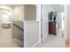 Hallway featuring staircase and an open doorway to a bedroom with plantation shutters at 417 Pennington Loop, Myrtle Beach, SC 29588