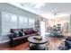 Bright living room with an open floor plan, hardwood floors, and views into the modern kitchen at 417 Pennington Loop, Myrtle Beach, SC 29588