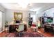 Well-lit living room with hardwood floors, shutters, and decorative paintings at 417 Pennington Loop, Myrtle Beach, SC 29588