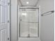 This bathroom showcases a glass shower with a silver frame, complemented by light gray walls and a matching towel rack at 4490 Barcelona Ln., Little River, SC 29566
