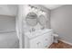 Bathroom featuring dual sinks with marble counters, modern lighting and round mirrors at 4490 Barcelona Ln., Little River, SC 29566