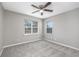 This is a gray bedroom with wall-to-wall carpeting and natural light from two windows at 4490 Barcelona Ln., Little River, SC 29566