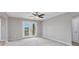 Bright bedroom with plush carpeting, neutral paint, ceiling fan and private access to the outdoor deck at 4490 Barcelona Ln., Little River, SC 29566