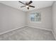 This is a gray bedroom with wall-to-wall carpeting, one window letting in light, and a ceiling fan at 4490 Barcelona Ln., Little River, SC 29566