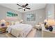 This cozy bedroom features bright natural light, neutral tones, beach-themed decor, and a comfy seating area at 4490 Barcelona Ln., Little River, SC 29566