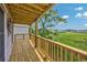 Private wood deck overlooking a serene marsh landscape and featuring wooden railings and a covered ceiling at 4490 Barcelona Ln., Little River, SC 29566