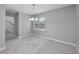 Neutral-toned empty dining room with modern chandelier, window and carpeted floor at 4490 Barcelona Ln., Little River, SC 29566