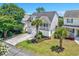 This charming coastal home features a two-car garage, lovely landscaping and a staircase to a cozy front porch at 4490 Barcelona Ln., Little River, SC 29566