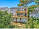 Two-story home featuring double decks for outdoor relaxation with a wooded backyard view at 4490 Barcelona Ln., Little River, SC 29566