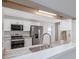 Modern kitchen featuring stainless steel appliances, marble countertops, and white cabinetry, offering a sleek design at 4490 Barcelona Ln., Little River, SC 29566