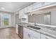 Well-lit kitchen boasts stainless steel appliances, bright cabinetry, and granite countertops at 4490 Barcelona Ln., Little River, SC 29566