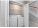 This laundry closet provides a washer and dryer, with shelving to maximize organization in a small space at 4490 Barcelona Ln., Little River, SC 29566
