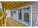 Inviting outdoor living space featuring a wooden deck with decorative crab, screened doors, and serene outdoor views at 4490 Barcelona Ln., Little River, SC 29566