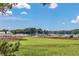 Scenic waterfront view featuring lush marshland and boats docked at a marina under a clear blue sky at 4490 Barcelona Ln., Little River, SC 29566