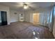 Spacious bedroom featuring plush carpeting, ceiling fan, and access to a large walk-in closet and ensuite bathroom at 454 Pacific Commons Dr., Surfside Beach, SC 29575