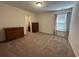 Bedroom featuring carpet, a ceiling fan, a window with curtains, dresser storage and a walk-in closet at 454 Pacific Commons Dr., Surfside Beach, SC 29575