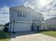 Two-story home featuring a well-maintained lawn, dark shuttered windows, attached garage, and basketball hoop at 454 Pacific Commons Dr., Surfside Beach, SC 29575