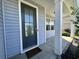 Front porch with views of the front door and trim with a glimpse of the neighborhood at 454 Pacific Commons Dr., Surfside Beach, SC 29575