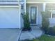 Close-up of front door framed by manicured shrubs and featuring a covered entrance with decorative trim at 454 Pacific Commons Dr., Surfside Beach, SC 29575