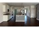 Modern kitchen with island, granite countertops, stainless steel appliances, and dark wood flooring at 454 Pacific Commons Dr., Surfside Beach, SC 29575