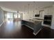 Open-concept kitchen with stainless steel appliances, granite countertops, and hardwood flooring throughout at 454 Pacific Commons Dr., Surfside Beach, SC 29575