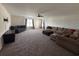 Large living room with ceiling fan, featuring ample seating and stylish accent wall, perfect for entertaining at 454 Pacific Commons Dr., Surfside Beach, SC 29575