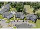 Aerial view of condos near a golf course with a swimming pool and lush landscaping at 493 White River Dr. # 28-D, Myrtle Beach, SC 29579