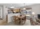 Bright dining area featuring a light wood table, chairs, and natural light from a window overlooking the outside at 493 White River Dr. # 28-D, Myrtle Beach, SC 29579